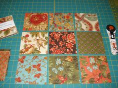 several pieces of fabric laid out on a cutting board