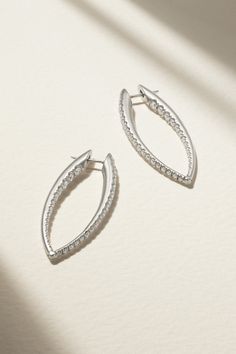 A sculptural take on classic hoops, Melissa Kaye's 'Cristina' earrings are a perfect example of how the designer draws on her engineering background. They're made from 18-karat white gold and traced with sparkling round-cut diamonds on the front and inside, ensuring they glitter beautifully in low light. Modern White Gold Earrings With Elegant Design, Modern Elegant White Gold Earrings, Modern Earrings With Timeless Design For Anniversary, Elegant White Gold Hoop Earrings Fine Jewelry, Modern Wedding Earrings With Timeless Design, Modern Polished Diamond Earrings For Wedding, Modern White Gold Diamond Earrings With Polished Finish, Modern Diamond Earrings For Formal Occasions, White Gold Jewelry With Timeless Design For Evening