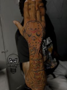 a man with tattoos on his arm and hand