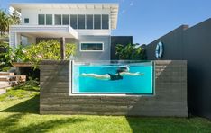 a swimming pool in front of a house with an above ground swimming pool on the side