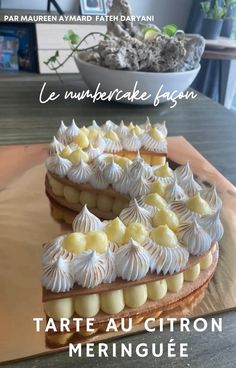 a cake with white frosting and yellow icing on top sitting on a table