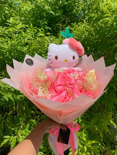 a person holding a hello kitty bouquet in their hand