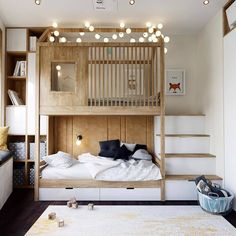 a bunk bed with stairs and lights above it in a room that has white rugs on the floor