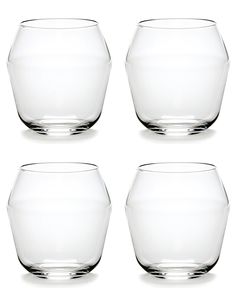 four clear glass vases sitting next to each other