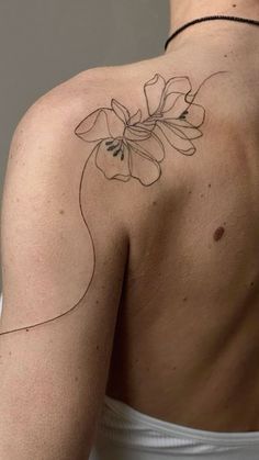 a woman with a flower tattoo on her back