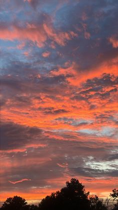 an orange and blue sky with some clouds