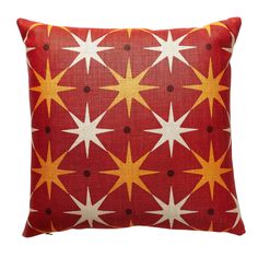 a red and yellow pillow with white stars on it