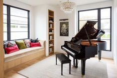 a living room with a couch and a grand piano