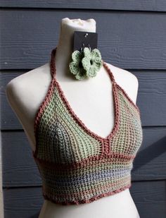 This top has a halter tie and an adjustable corset back to accommodate different size waists and rib cages. The primary color is a variegated brown and green yarn with a light brown accent yarn. This is a simpler pattern that allows for more coverage than some of our other tops. Earrings pictured sold separately Fitted Brown Triangle Halter Top, Brown Fitted Triangle Halter Top, Fitted Brown Halter Neck Crop Top, Fitted Bohemian Brown Crop Top, Fitted Brown Halter Top For Spring, Casual Brown Fitted Halter Top, Green Fitted Bohemian Halter Top, Tops Earrings, Candy Corn Earrings