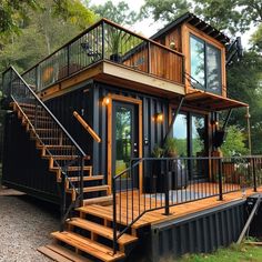 a house made out of shipping containers with stairs