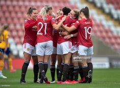 the women's soccer team huddle together on the field