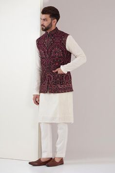 Maroon sleeveless Nehru jacket with kashmiri, sequin, thread embroidery in floral pattern.
Components: 1
Pattern: Embroidery
Type Of Work: Kashmiri, thread, sequin, floral
Neckline: Mandarin collar
Sleeve Type: Sleeveless
Fabric: Georgette
Color: Maroon
Other Details: 
Note: Inner kurta and pant worn by the model is not for sale
Occasion: Destination Wedding - Aza Fashions Embroidery Nehru Jacket For Men, Kurta And Nehru Jacket For Men, Mens Nehru Jacket With Shirt, Maroon Kurta Men With Jacket, Kurta Nehru Jacket Men, Men’s Kurta With Jacket, Sleeveless Nehru Jacket With Zari Work, Designer Sleeveless Embroidered Nehru Jacket, Sleeveless Embroidered Nehru Jacket For Designer Wear