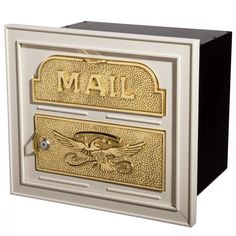 the mailbox is decorated with gold and black letters that read mail, eagle, and skull