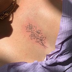 a woman with a flower tattoo on her chest