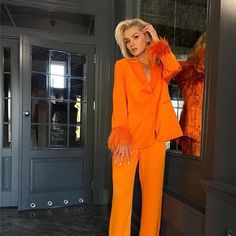 This is two-piece suit is the perfect combination of style and professionalism. The orange color will match any skin tone with ease, while the feather trim will make you look both feminine and chic. Suits For Women Stylish, Feather Sleeves, Fluffy Sleeves, Orange Two Piece, Orange Suit, Pant Suits For Women, Orange Coat, Statement Outfit, Satin Blazer