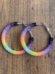 A pair of hoop earrings made with limited edition UV reactive neon seed beads. Comes in one of three sizes!  30mm (1 inch) 40mm (1.5 inch) 50mm (2 inch) These one of a kind earrings are fantastic for raves, night clubs, parties, summer vacations, festivals or just for a pop of color in your wardrobe.  Made with a spring clasp for ease. Hypoallergenic professional grade metals, none of the cheap stuff used here! Want another size or have something else in mind? Send me a message! Cheap Beaded Hoop Earrings For Summer, Cheap Summer Beaded Hoop Earrings, Cheap Colorful Beaded Festival Jewelry, Cheap Rainbow Hoop Earrings For Party, Affordable Small Hoop Beaded Earrings For Festivals, Cheap Hoop Earrings For Celebrations And Festivals, Cheap Hoop Earrings For Party And Festivals, Cheap Festive Hoop Earrings For Festivals, Cheap Hypoallergenic Beaded Earrings For Party