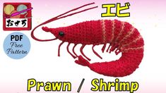 the crocheted shrimp is red and has white stripes on it's tail