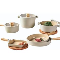 four pots and pans with wooden handles