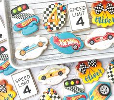 decorated cookies in the shape of race cars and numbers are on display for children to enjoy