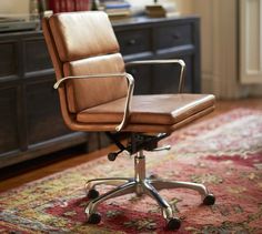 a brown office chair sitting on top of a rug