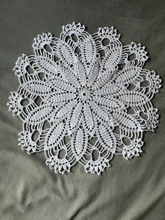 a white doily sitting on top of a bed