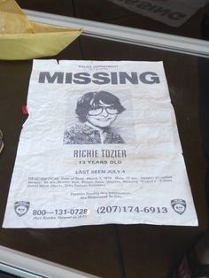 a missing poster is on the table next to a banana