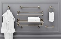 a towel rack and two towels hanging on the wall next to a bath robe rack