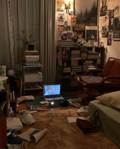 a laptop computer sitting on top of a rug in a living room filled with furniture