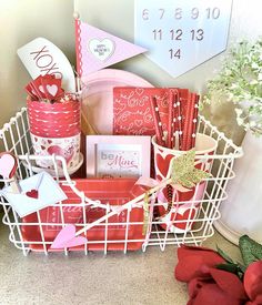 a white basket filled with lots of valentine's day items