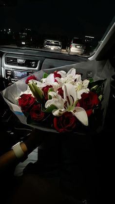 a bouquet of flowers sitting in the center console of a car