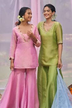 Pink short kurta with zardozi, sequin embroidery in scallop pattern on neckline. Paired with sharara and dupatta. - Aza Fashions Raw Silk Sets With Sheer Dupatta, Tissue Silk Traditional Drape Sets, Semi-stitched Raw Silk Palazzo Set, Pista Green Dupatta With Dori Work, Wedding Tissue Silk Salwar Kameez, Wedding Sets With Gota Work, Unstitched Sharara For Designer Wear, Anarkali Palazzo Set With Dori Work, Pista Green Salwar Kameez With Gota Work