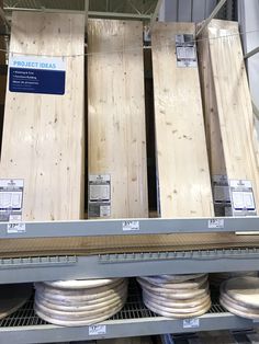 several wooden boards are stacked on top of each other in a store display case with labels reading project ideas