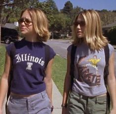 two young women walking down the sidewalk together