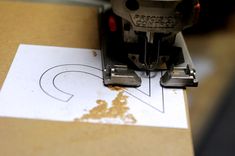 a close up of a machine that is cutting paper with a hole in the middle