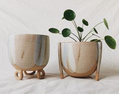 two planters sitting next to each other on a white surface