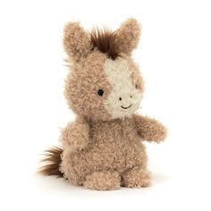 a small stuffed horse sitting up against a white background