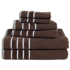 six towels stacked on top of each other in brown and white striped pattern, with one folded