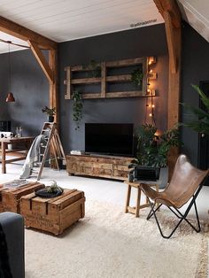 a living room filled with furniture and a flat screen tv on top of a wooden stand