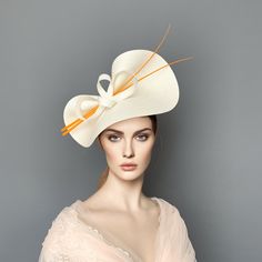 Elegant Orange and Ivory Kentucky derby hat for woman. This Orange and cream fascinate hat is embellished with a two ostrich quills and a beautiful bow. It is a perfect hat for weddings, Royal Ascot horse races, cocktails, derby... It is mounted on a headband. If you want, you can choose the side of the head were you like to wear the fascinator, just convo me. Any color of the fascinator can be changed to order. Elegant Kentucky Derby Hat With Bow, Elegant Bow Hat For Kentucky Derby, Elegant Cream Hat With Bow, Cream Brimmed Fascinator For Formal Occasions, White Hat With Bow And Short Brim, Elegant White Top Hat For Kentucky Derby, Chic Cream Straw Hat For Kentucky Derby, Formal Cream Brimmed Mini Hats, Elegant White Headpiece For Kentucky Derby