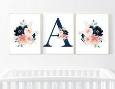 two floral wall art prints with the letter a and flowers in navy blue, pink and white