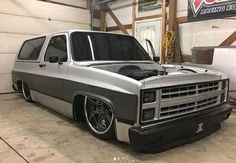 a silver truck parked inside of a garage