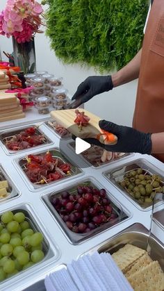 a table topped with lots of trays filled with different types of foods and vegetables