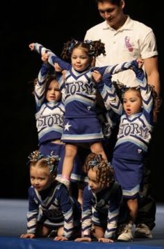 a group of cheerleaders standing on top of each other