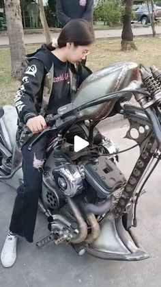 a young man sitting on top of a motorcycle