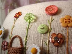 a pillow with buttons and flowers on it