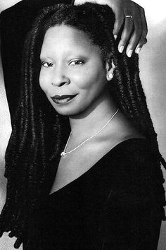 a black and white photo of a woman with dreadlocks