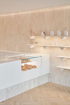 an empty bakery display case with donuts in it