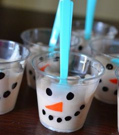 snowman pudding cups with toothbrushes in them sitting on a table next to each other