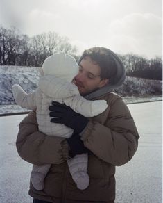 a man holding a baby in his arms