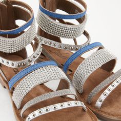 Azura Style: Belalia Premium leather European influenced multi strap gladiator style sandal. It's a fabulous mix of polished metal studs, rhinestones and metallic textured strap designs. This shoe has it all. Heel Height (approximately): 1/2", 1/4" platform. Features: -High quality leather upper, round toe silhouette, hand-sewn bead work. -Full length back heel zipper with a polished metal zipper pull. -Supple soft leather lining. -Comfort padded suede insole. -Rubber outsole with a flexible for Ankle Sandals, Spring Step Shoes, Rhinestone Designs, Comfortable Sandals, Metal Zipper, Slingback Sandal, High Quality Leather, New Shoes, Hand Sewn